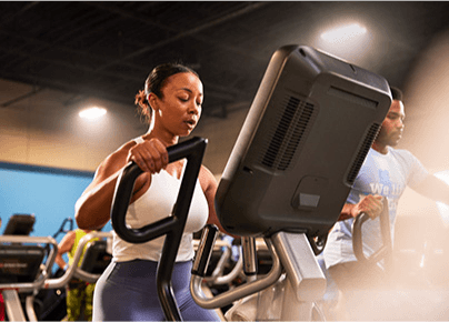 eos gym member on cardio equipment inside an eos branded gym