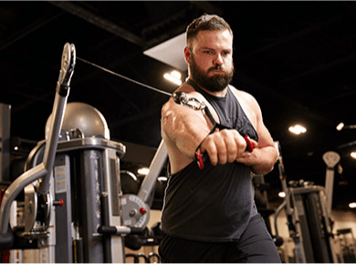 eos gym member working on on cable machine