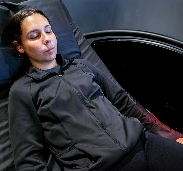 an eos gym member relaxing in a high tech massage chair