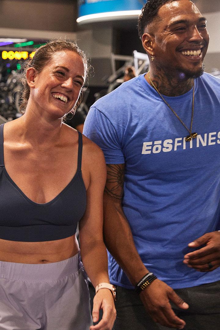 two smiling eos gym members wearing athletic clothes