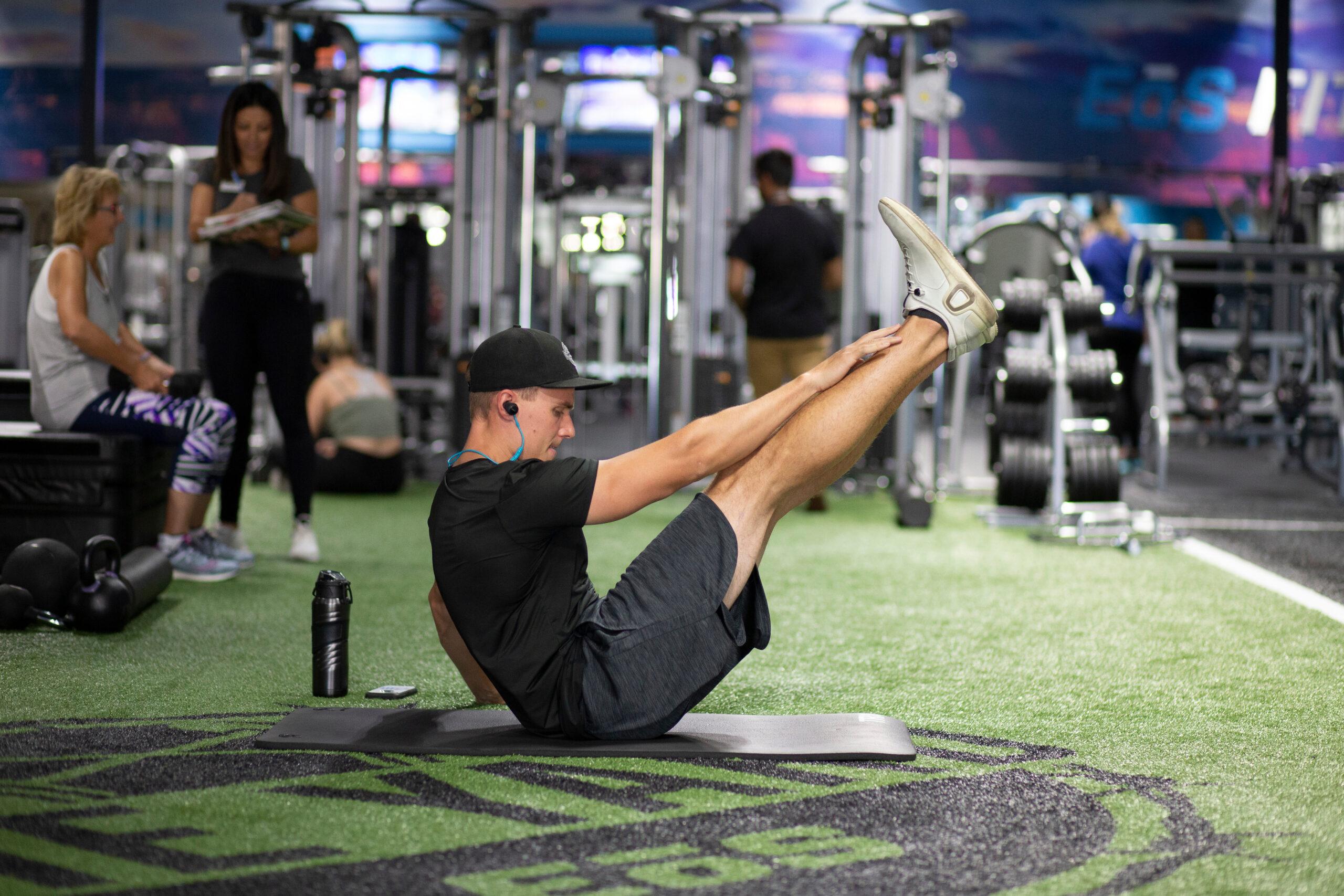 eos gym member doing an core exercise in a well lit eos branded box gym