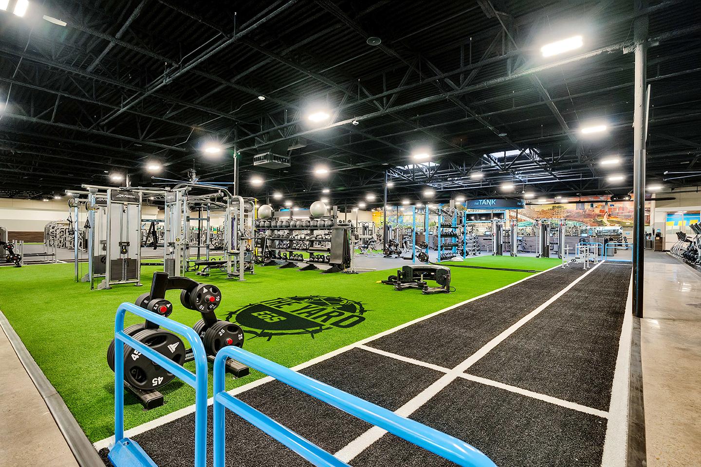 a wide shot of the inside of a eos gym showing off several machines and amenities 