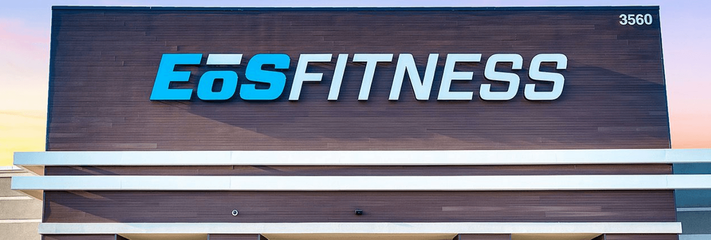 Exterior view of an EoS Fitness gym with prominent branding on the building