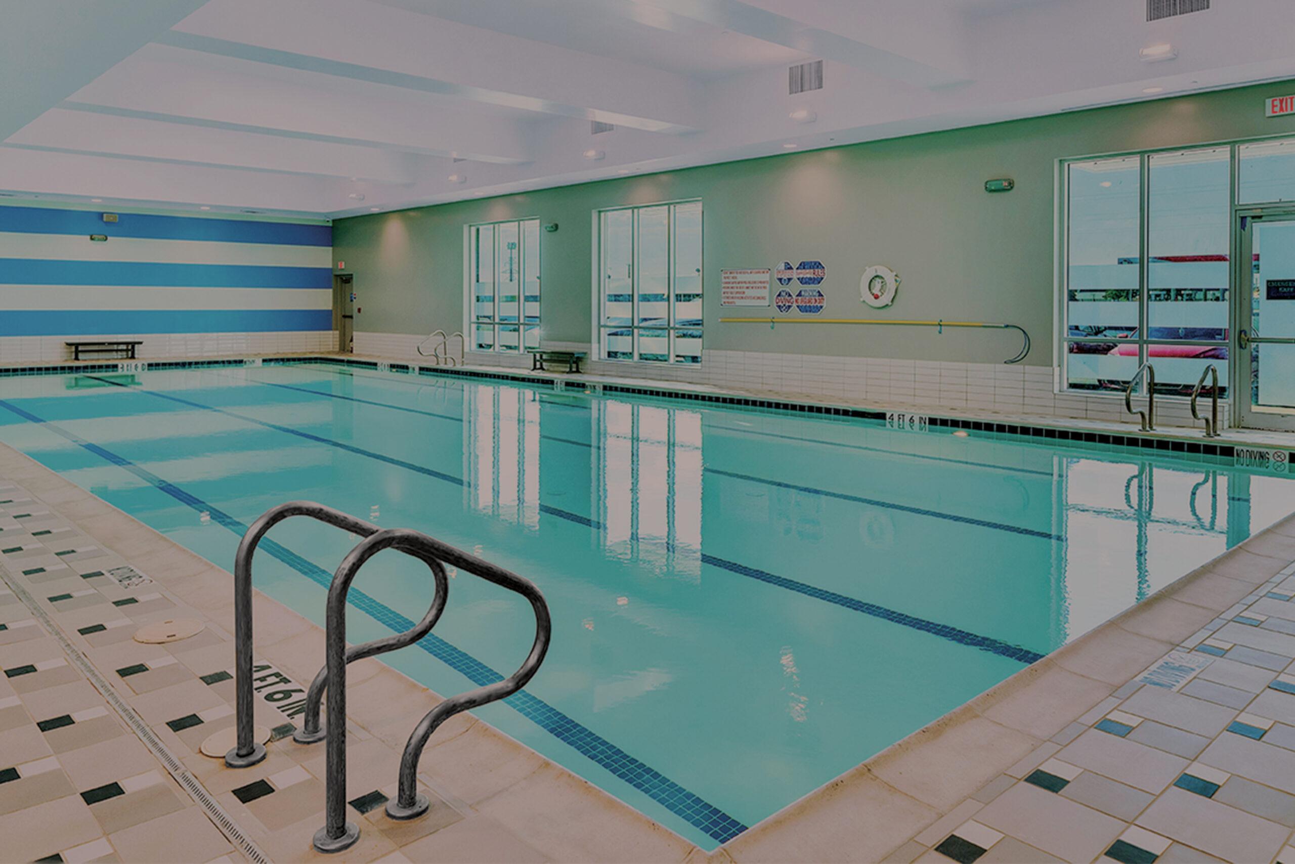 a well lit shot of an eos branded indoor lap pool