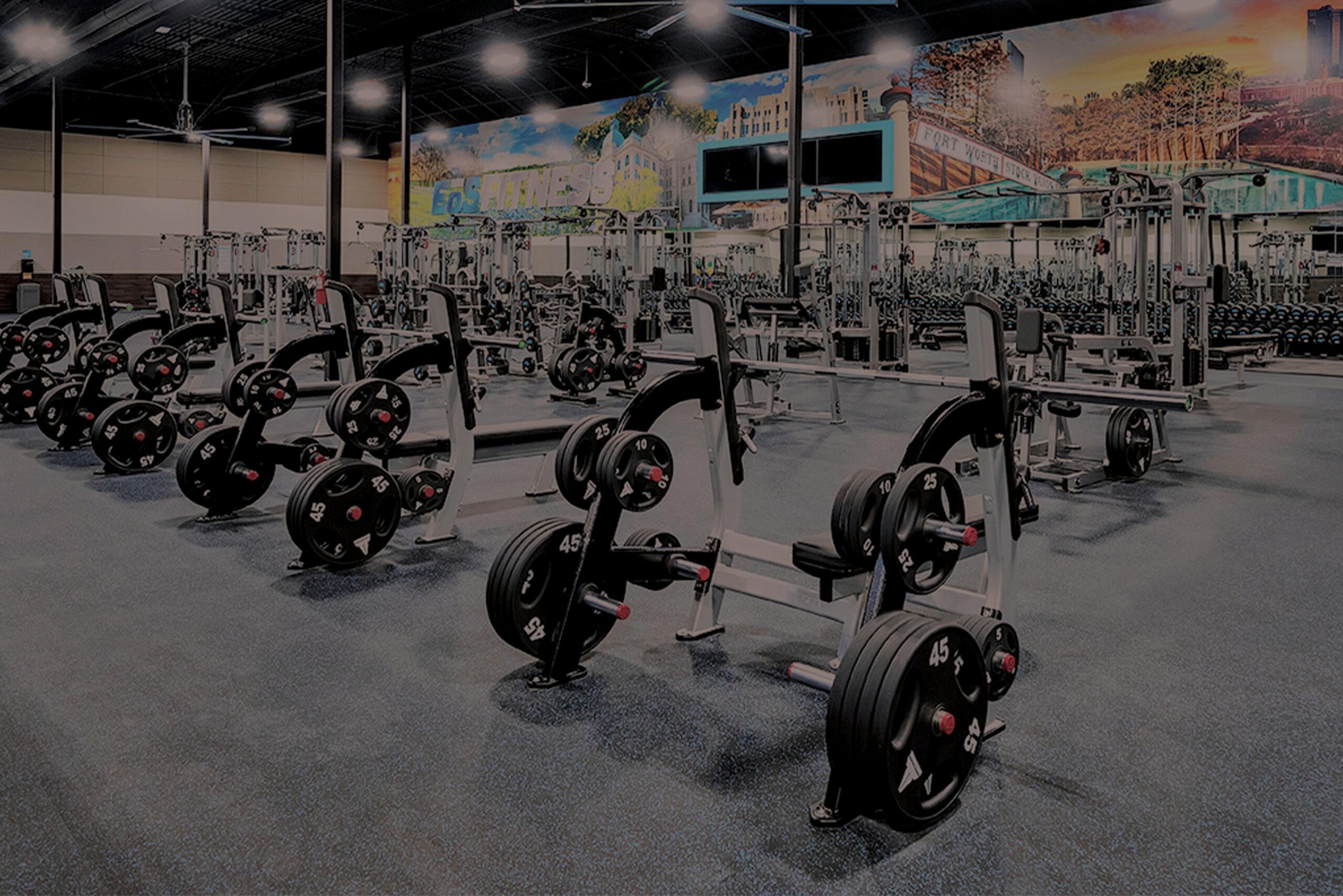 wide show of workout benches and other barbell strength equipment in an eos branded gym