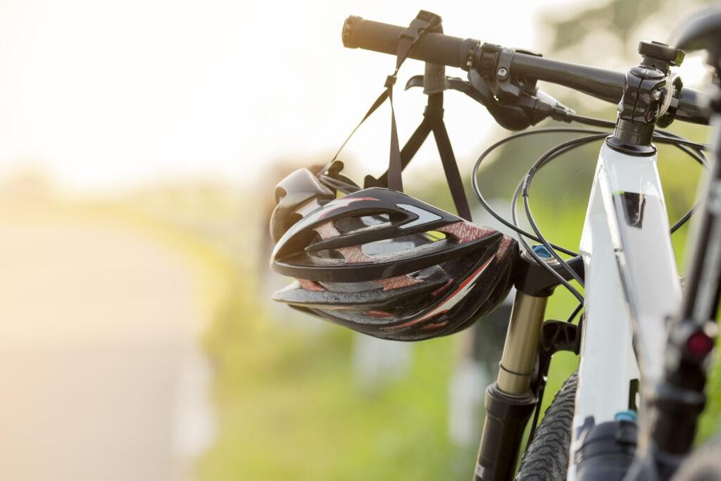 close up helmet hanging on bike handle.