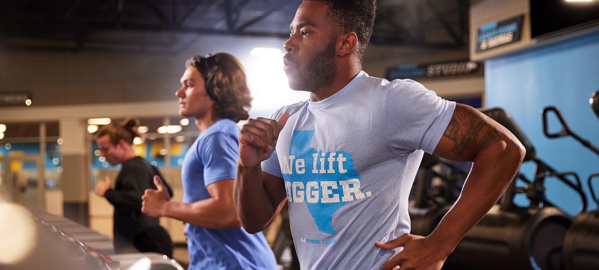 two eos members on cardio equipment running