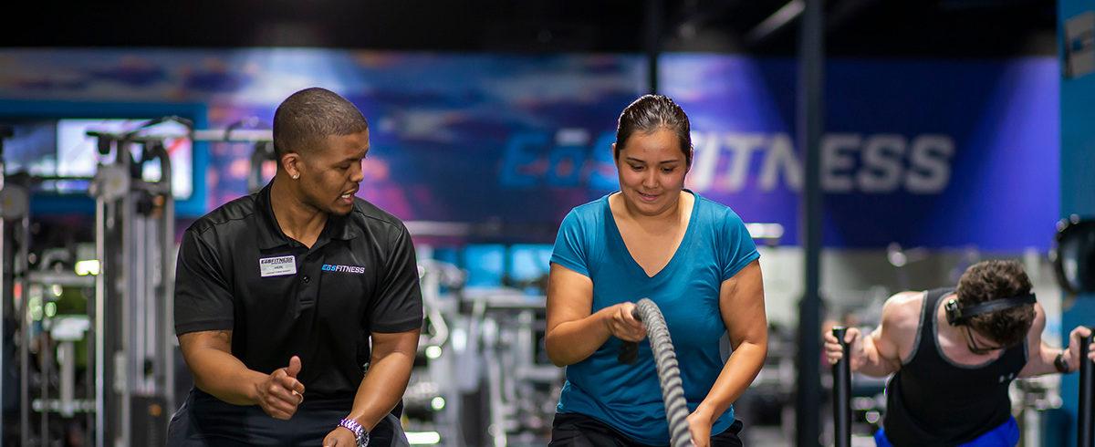 eos gym member working with Personal Trainer in a modern box gym