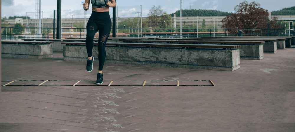 athletic person performing agility training exercises outside