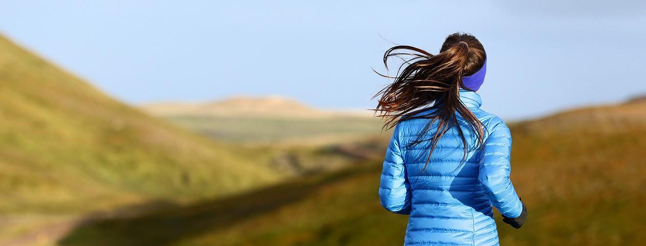 athletic person running outside on a sunny day