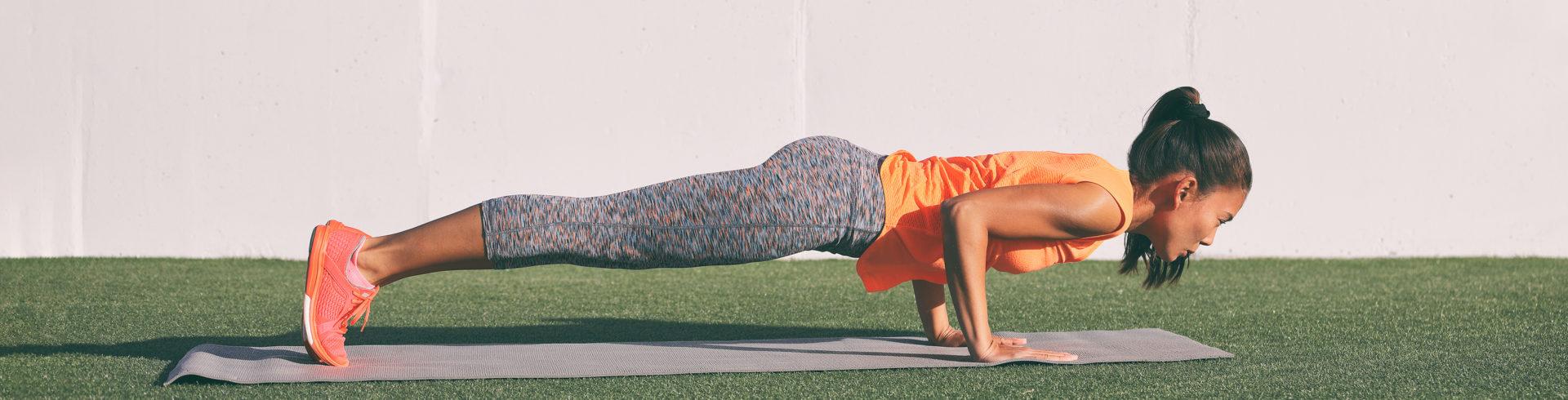 Yoga fitness woman practicing chaturanga pose push ups press up