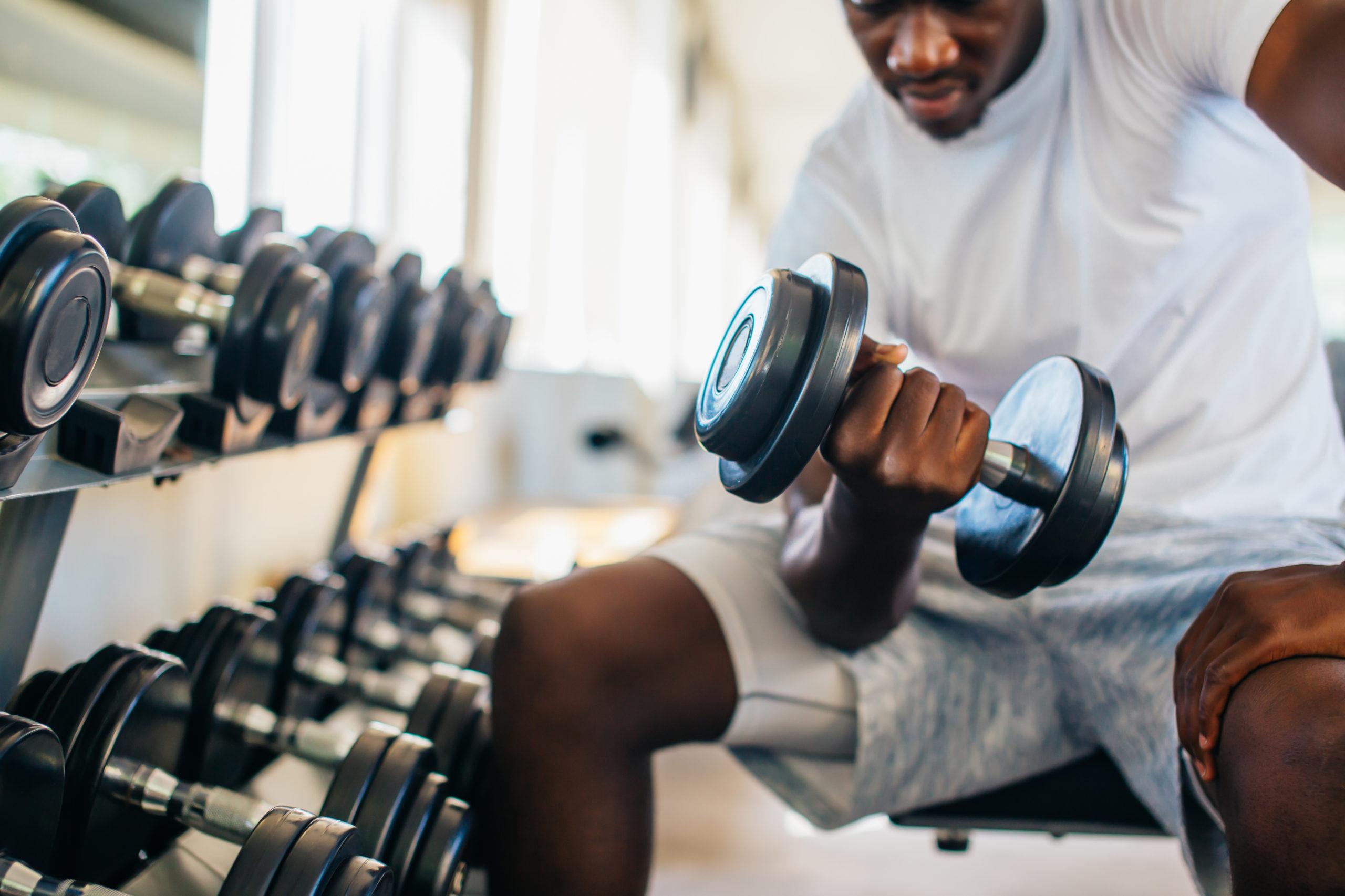 Man performing a leaning biceps curl.