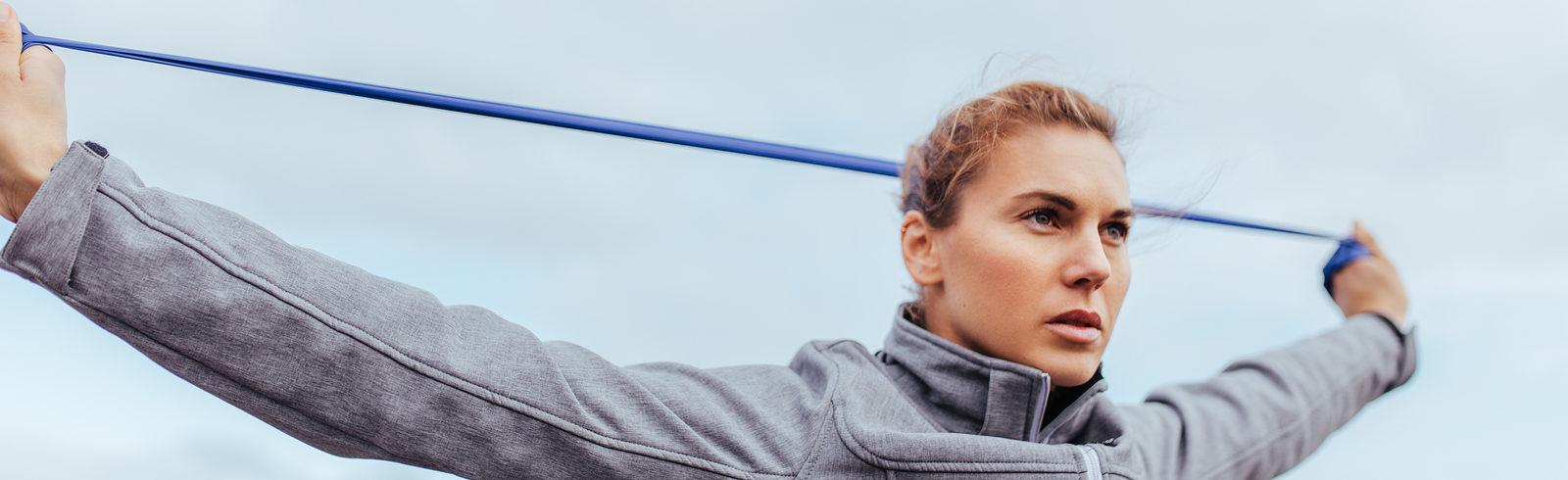 eos gym member looking focused while doing Resistance Band Training