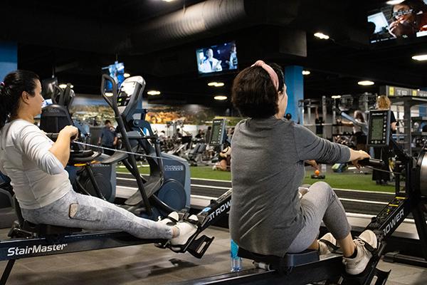 eos gym members on rowing machines