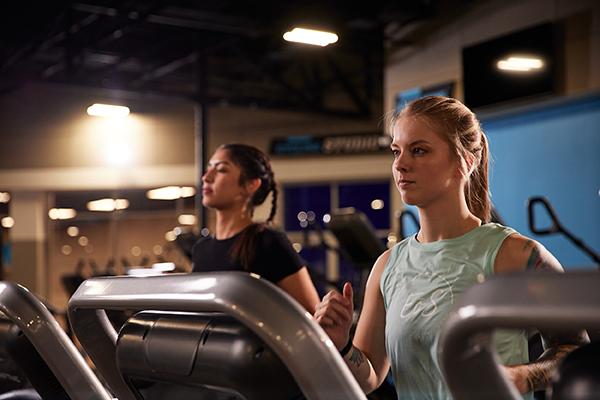 eos gym member running on a treadmill