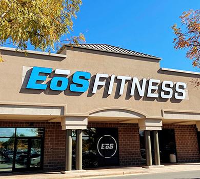 outside shot of a modern eos gym with brick walls and bright blue branding