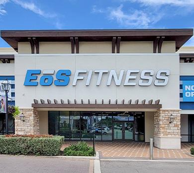 outside shot of a modern eos gym with brick walls and bright blue branding