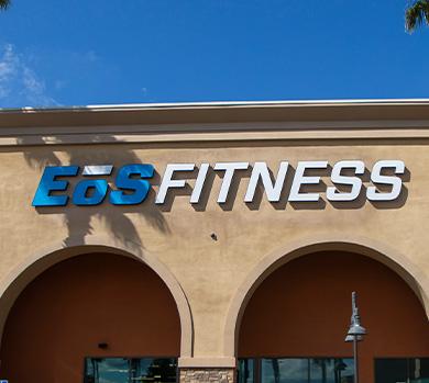 outside shot of a modern eos gym with brick walls and bright blue branding