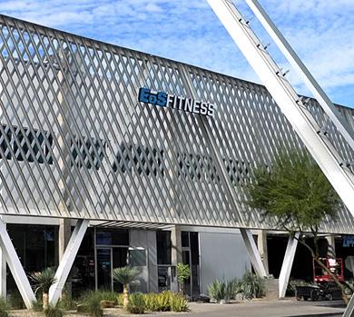 outside shot of a modern eos gym with brick walls and bright blue branding