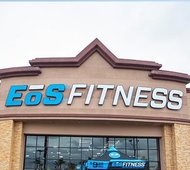 outside shot of a modern eos gym with brick walls and bright blue branding