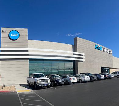 outside shot of a modern eos gym with brick walls and bright blue branding