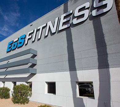 outside shot of a modern eos gym with brick walls and bright blue branding