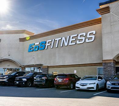 outside shot of a modern eos gym with brick walls and bright blue branding