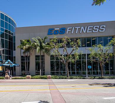 outside shot of a modern eos gym with brick walls and bright blue branding