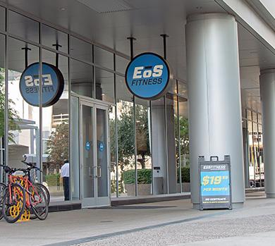 outside shot of a modern eos gym with brick walls and bright blue branding