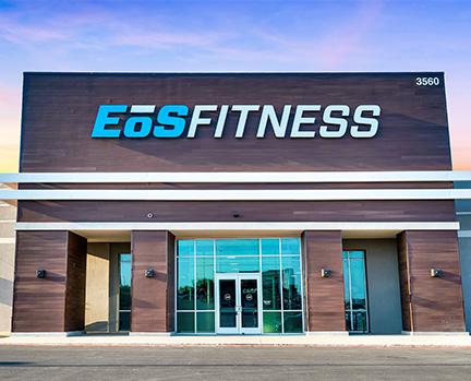 outside shot of a modern eos gym with brick walls and bright blue branding