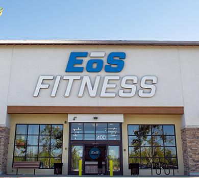 outside shot of a modern eos gym with brick walls and bright blue branding