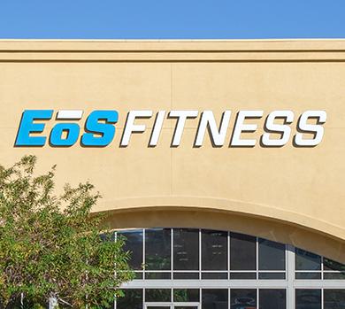 outside shot of a modern eos gym with brick walls and bright blue branding