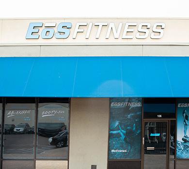 outside shot of a modern eos gym with brick walls and bright blue branding