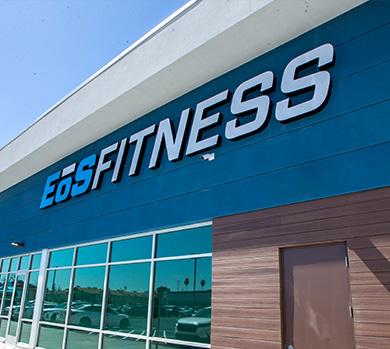 outside shot of a modern eos gym with brick walls and bright blue branding