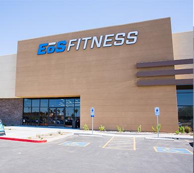outside shot of a modern eos gym with brick walls and bright blue branding