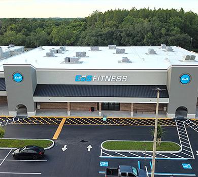 outside shot of a modern eos gym with brick walls and bright blue branding