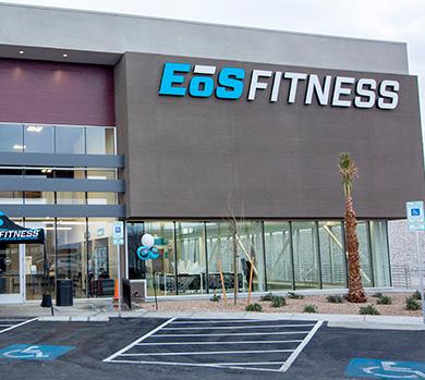 outside shot of a modern eos gym with brick walls and bright blue branding