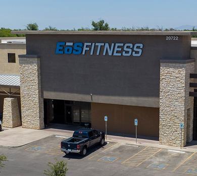 outside shot of a modern eos gym with brick walls and bright blue branding