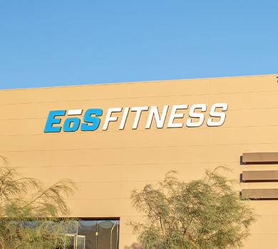 outside shot of a modern eos gym with brick walls and bright blue branding