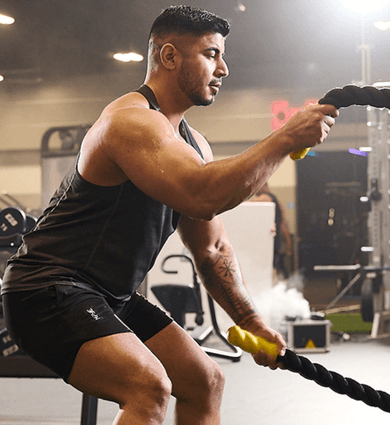 eos fitness member using battle ropes in the gym
