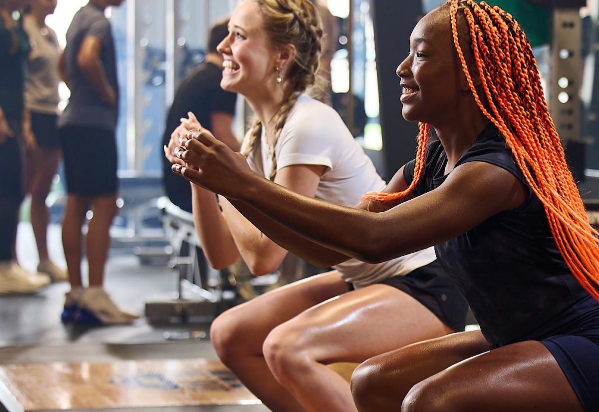two eos gym members warming up together before a workout