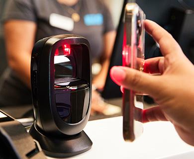 close up shot of phone scanning at the front desk to check in