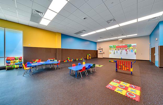 empty kids club room with a play pad and table