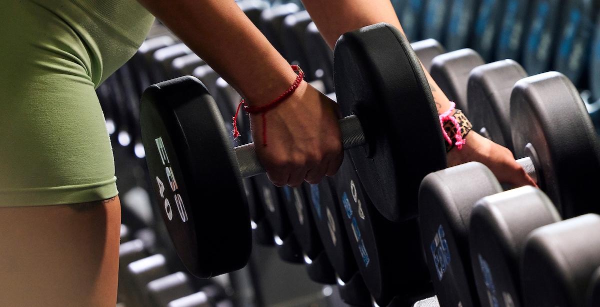 eos gym member starting to work out with dumbbells
