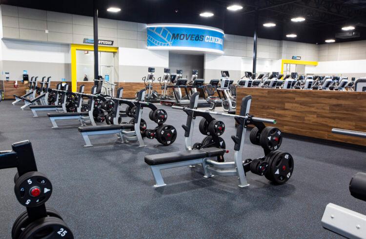 EoS gym with bench press stations and cardio equipment in the background