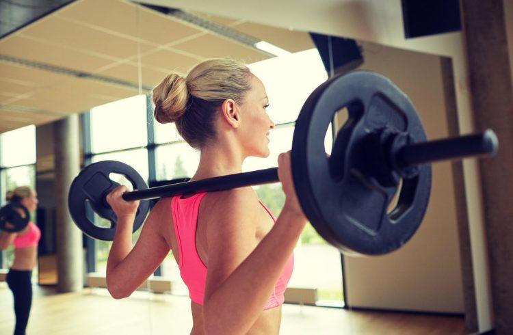 Woman lifting a barbell during a workout class