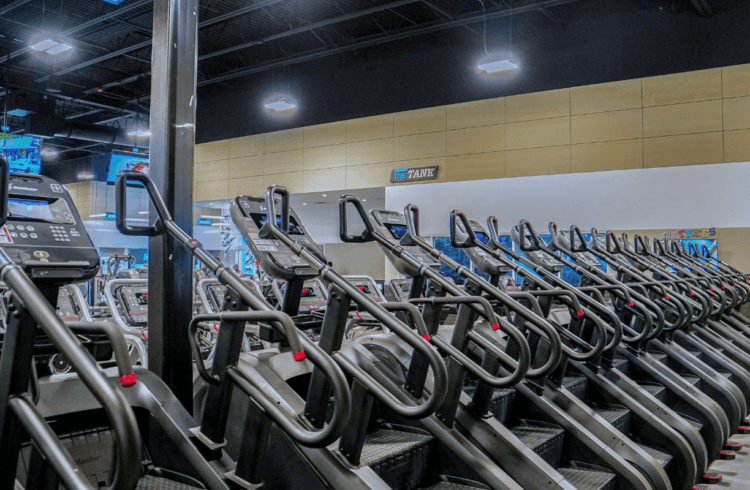 a row of EōS Fitness Stairmaster gym equipment