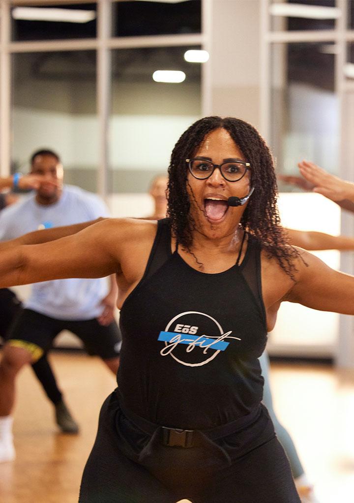 close up of group dance class being lead on by an excited instructor