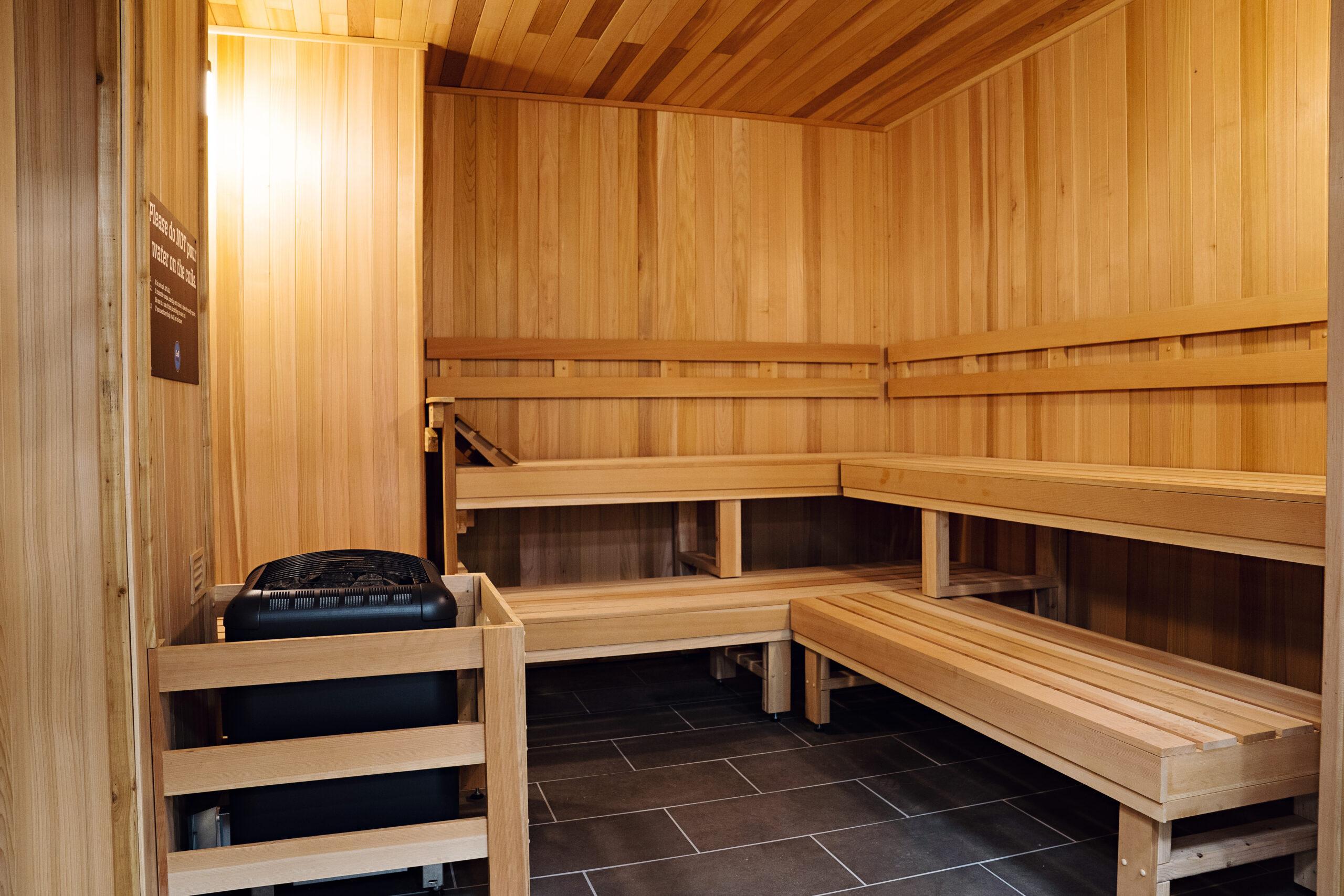 inside of a clean sauna room with wooden paneling
