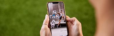 an eos gym member looking down at their phone